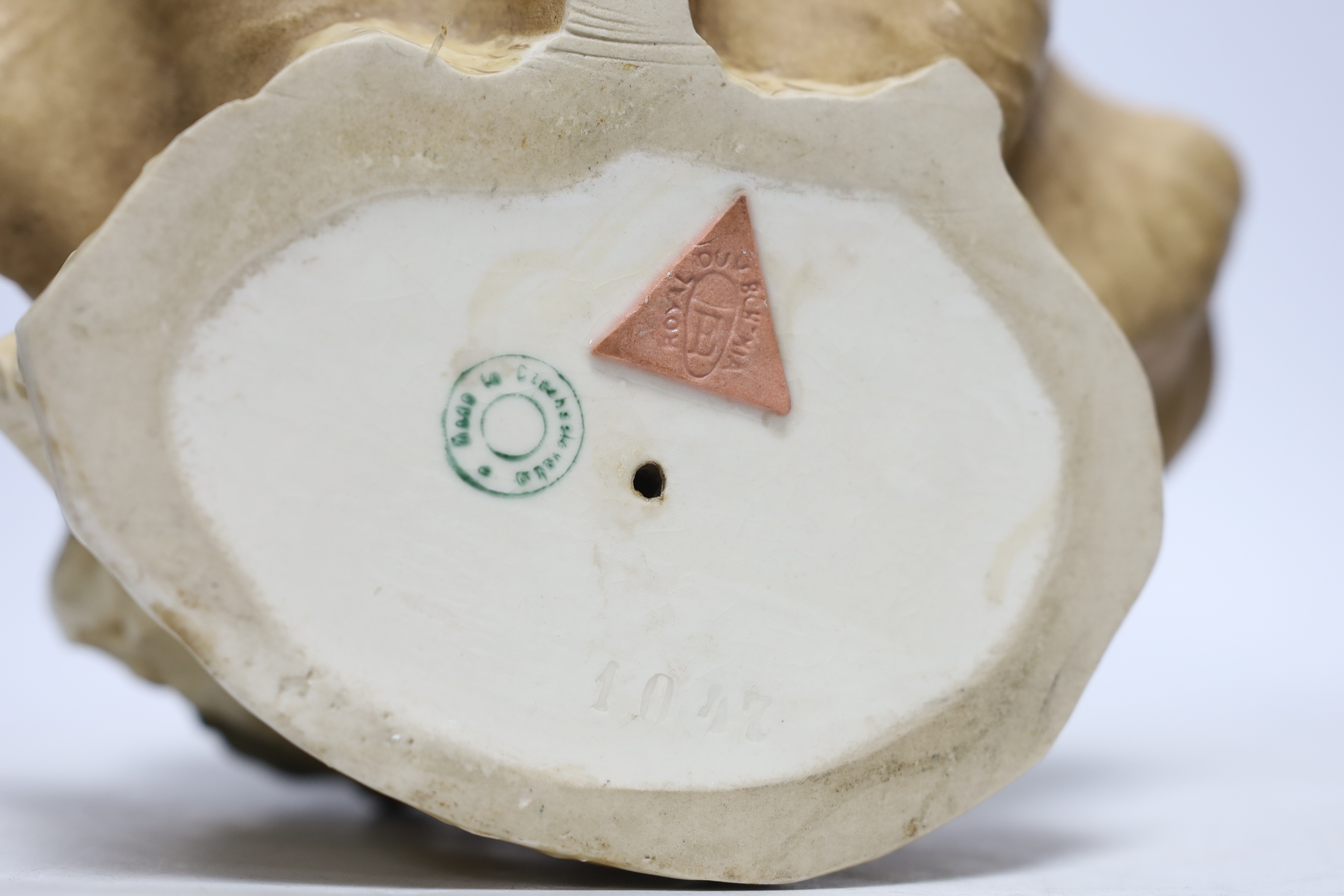A Royal Dux figure of a water carrier by a shell shaped pool, 26cm high